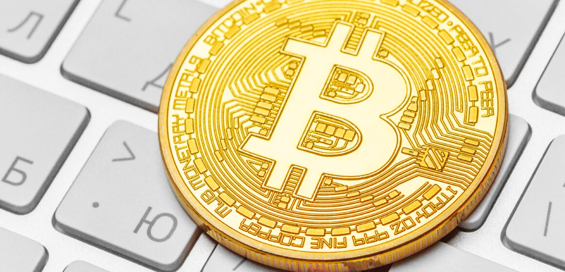 Close-up of a physical bitcoin on keyboard Close-up of a physical bitcoin on keyboard