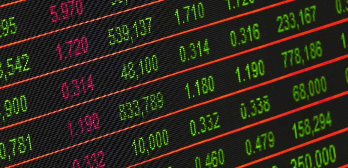 Wall Street Treads Water As Fed Decision Looms And AI Chip Headlines Swirl Traders watching stock indexes on large screens ahead of a Fed decision