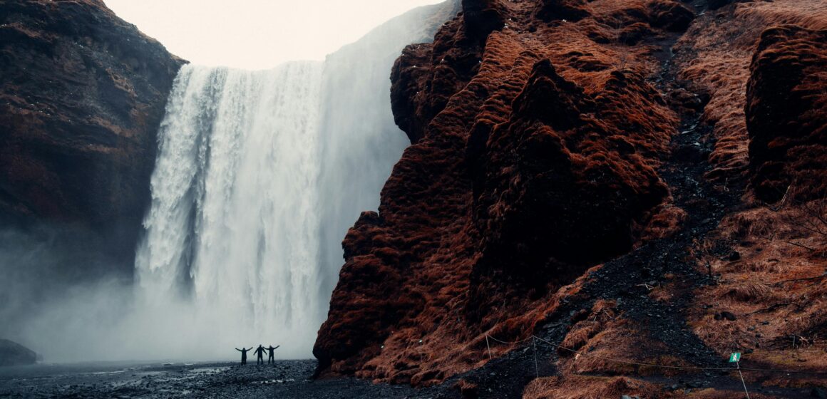 Person walking alone at sunrise with headphones and a journal, symbolizing self reinvention